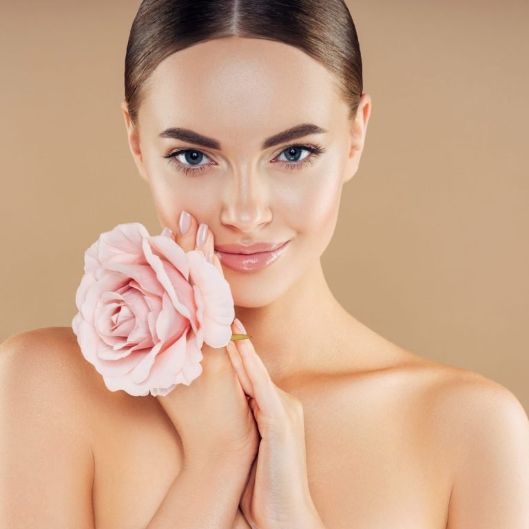 Beautiful woman with rose. Natural soft make-up.