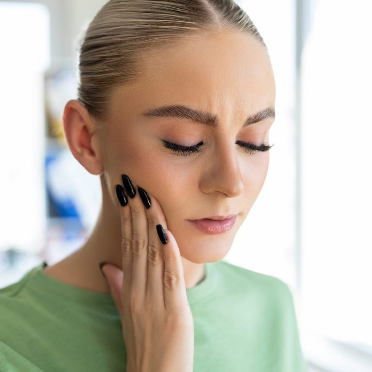 Young woman with tooth ache